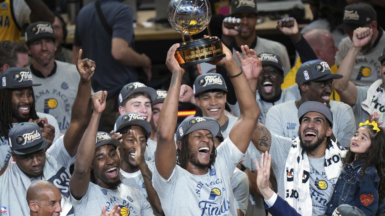 Indiana Pacers center Myles Turner holds the trophy as players celebrate after winning Game 6 of the Eastern Conference finals of the NBA basketball playoffs against the New York Knicks in Indianapolis, Saturday, May 31, 2025.