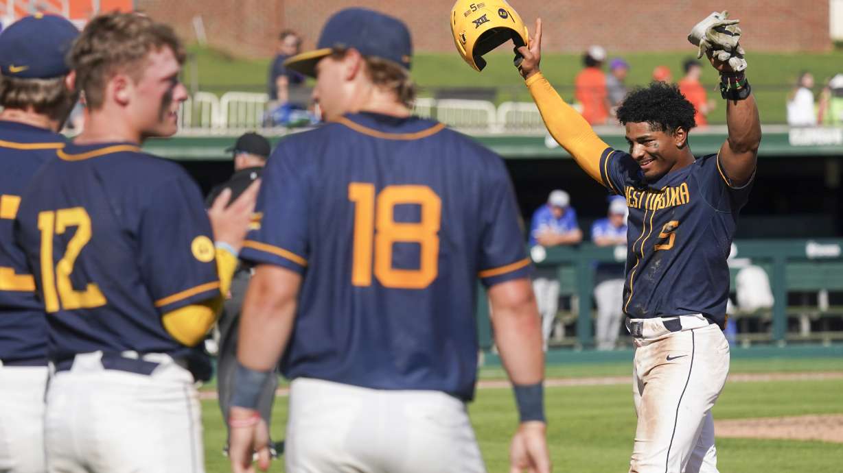 FILE - West Virginia utility Armani Guzman (5) celebrates after an NCAA regional college baseball game against Kentucky, May 30, 2025, in Clemson, S.C.
