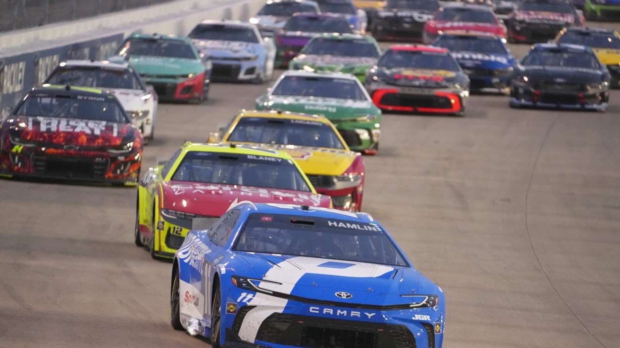 Denny Hamlin (11) leads the pack of cars through turn three during a NASCAR Cup Series auto race Sunday, June 1, 2025, in Lebanon, Tenn.