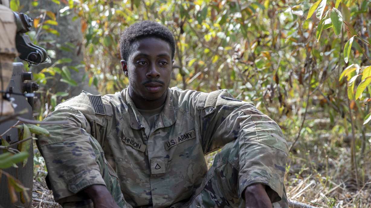 Army Pfc. Dewayne Johnson sits with his teammates at Helemano Military Reservation in Wahiawa, Hawaii, Nov. 2, 2023. Johnson was sentenced Thursday to 23 years in prison for killing his wife and unborn child.