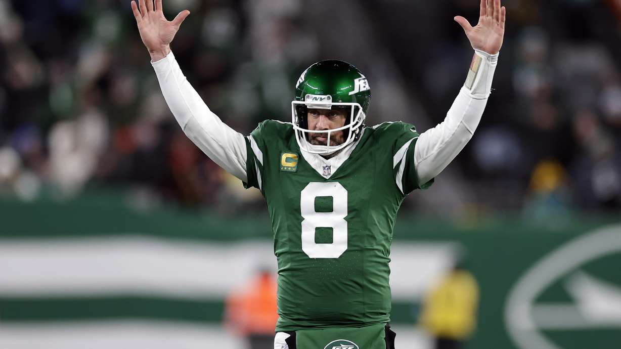 FILE - New York Jets quarterback Aaron Rodgers (8) reacts after a touchdown pass during an NFL football game against the Miami Dolphins Sunday, Jan. 5, 2025, in East Rutherford, N.J.