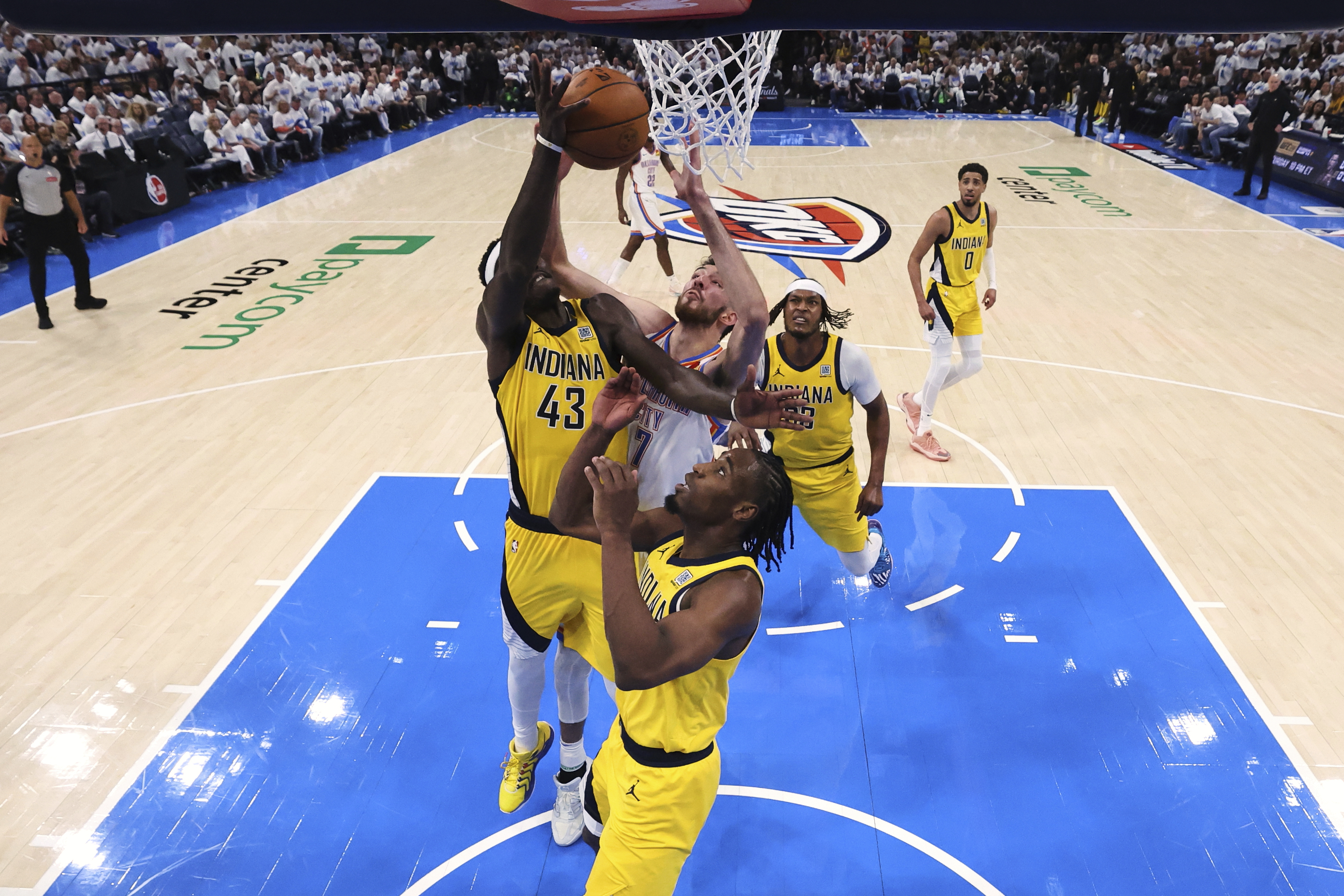 Oklahoma City Thunder forward Chet Holmgren (7), Indiana Pacers forward Pascal Siakam (43) and forward Aaron Nesmith (23) reach for the ball during Game 1 of the NBA Finals basketball series Thursday, June 5, 2025, in Oklahoma City.