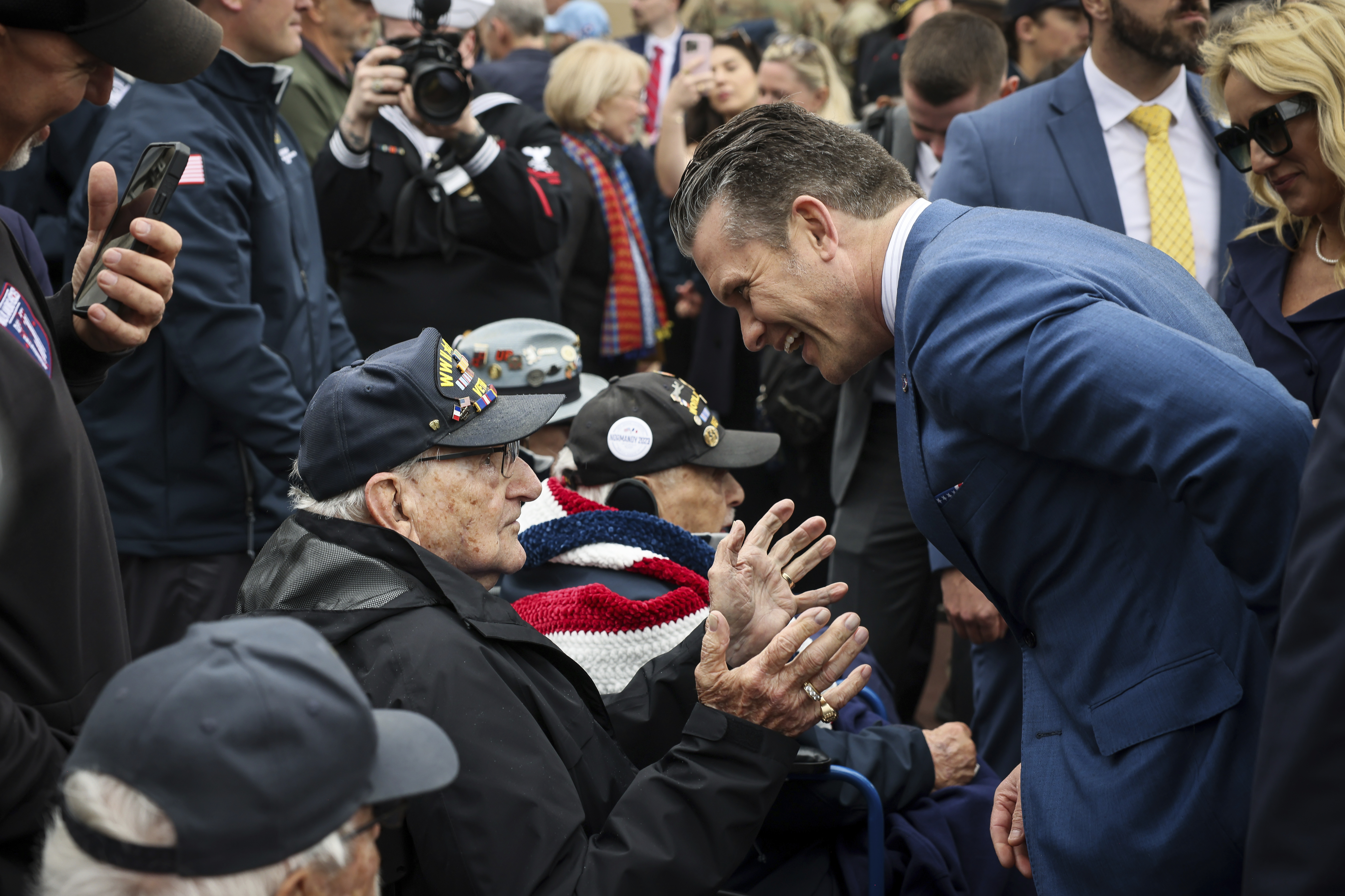 Defense Secretary Pete Hegseth, and his wife Jennifer Rauchet, right, meet American WWII veterans at the U.S. cemetery as they commemorate the 81st anniversary of the D-Day landings, Friday, in Colleville-sur-Mer, Normandy, France.