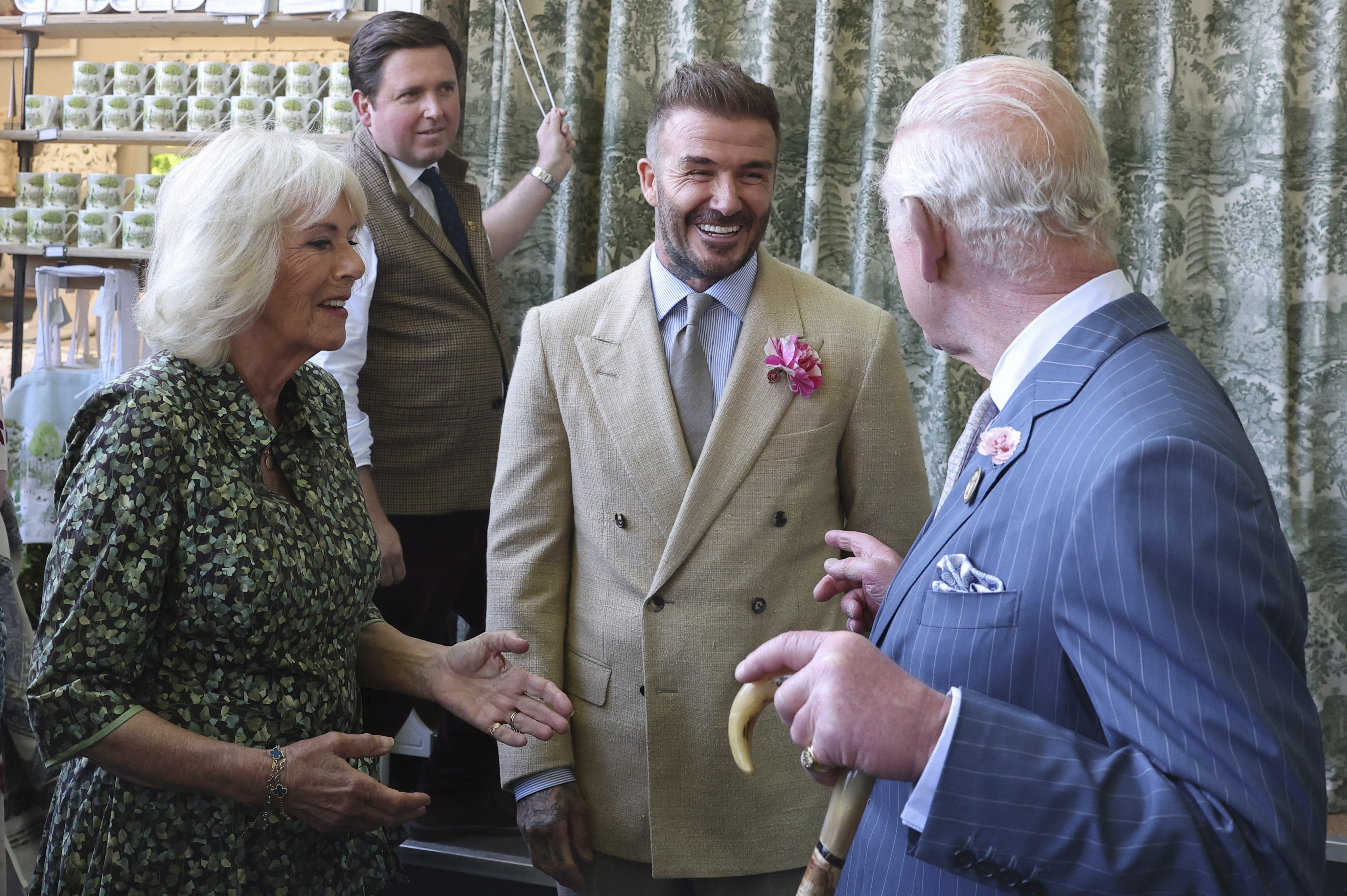 Britain's King Charles III and Queen Camilla speak with David Beckham at the Chelsea Flower Show in London, Monday May 19, 2025. 