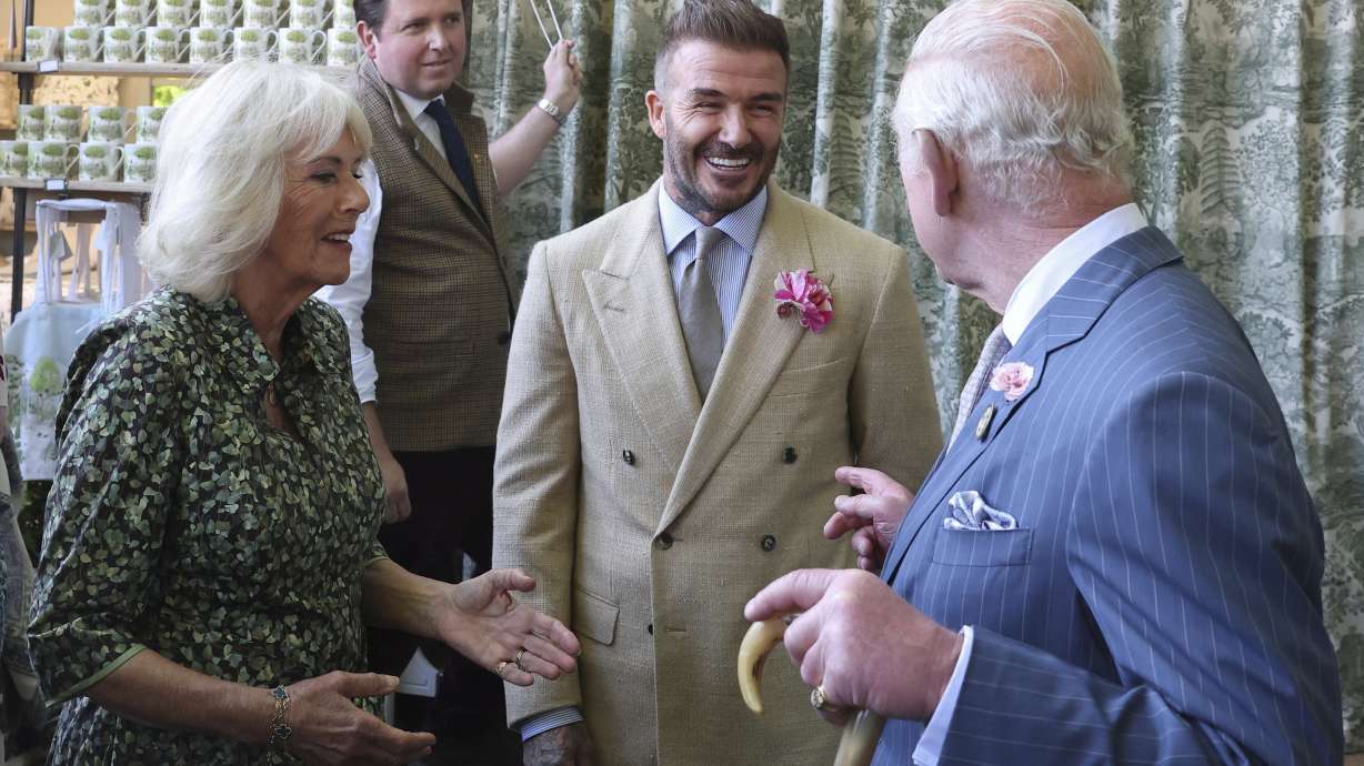 Britain's King Charles III and Queen Camilla speak with David Beckham at the Chelsea Flower Show in London, Monday May 19, 2025.