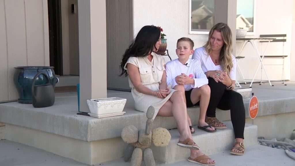 Jason Thorpe sits with his mom Anne Thorpe, left, and neighbor Helena Class-Alexander, who gave the 12-year-old CPR after he was face down in a hot tub in May, on Thursday in Eagle Mountain.