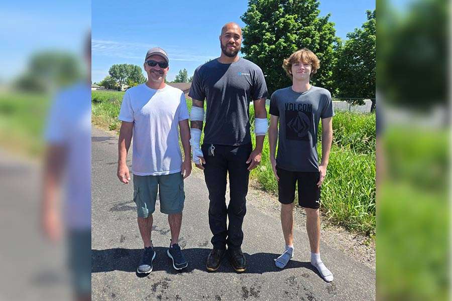 An unidentified man, Nate Lee and Mason Bates after rescuing Cindy Parker Tuesday. They expressed gratitude for working together to rescue Parker.