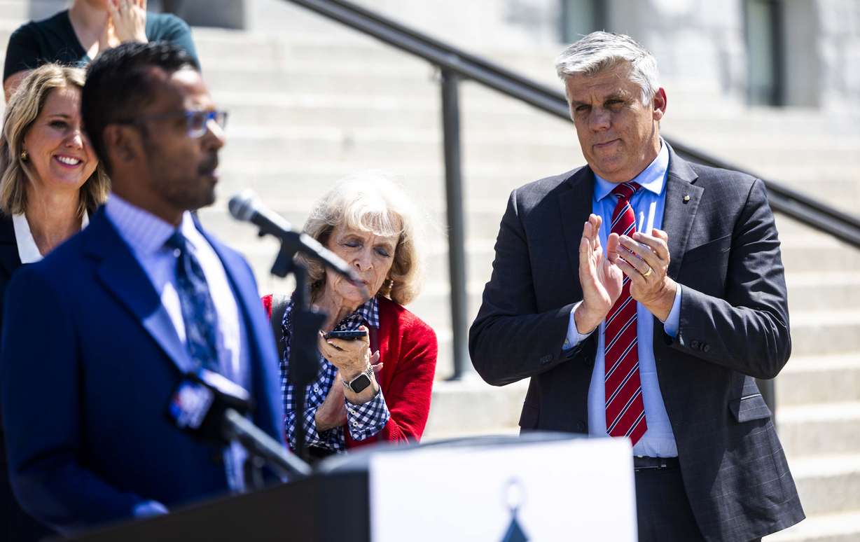 Phil Lyman claps as he listens to his attorney, Goud Maragani, speak at a press conference announcing a lawsuit to require Utah Lt. Gov. Deidre Henderson to give Lyman a copy of the Statewide Voter Registration List, at the Capitol in Salt Lake City on Friday.