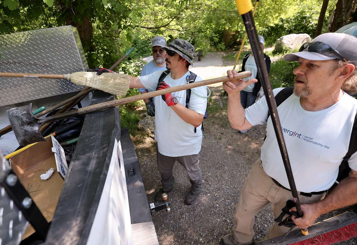Convergint employees Tim Droge, Brandon Cameron and Blake Hickman load equipment into the back of a pickup truck during a company volunteer trail maintenance day with Cottonwood Canyons Foundation in Millcreek Canyon on Friday. Saturday is National Trails Day.
