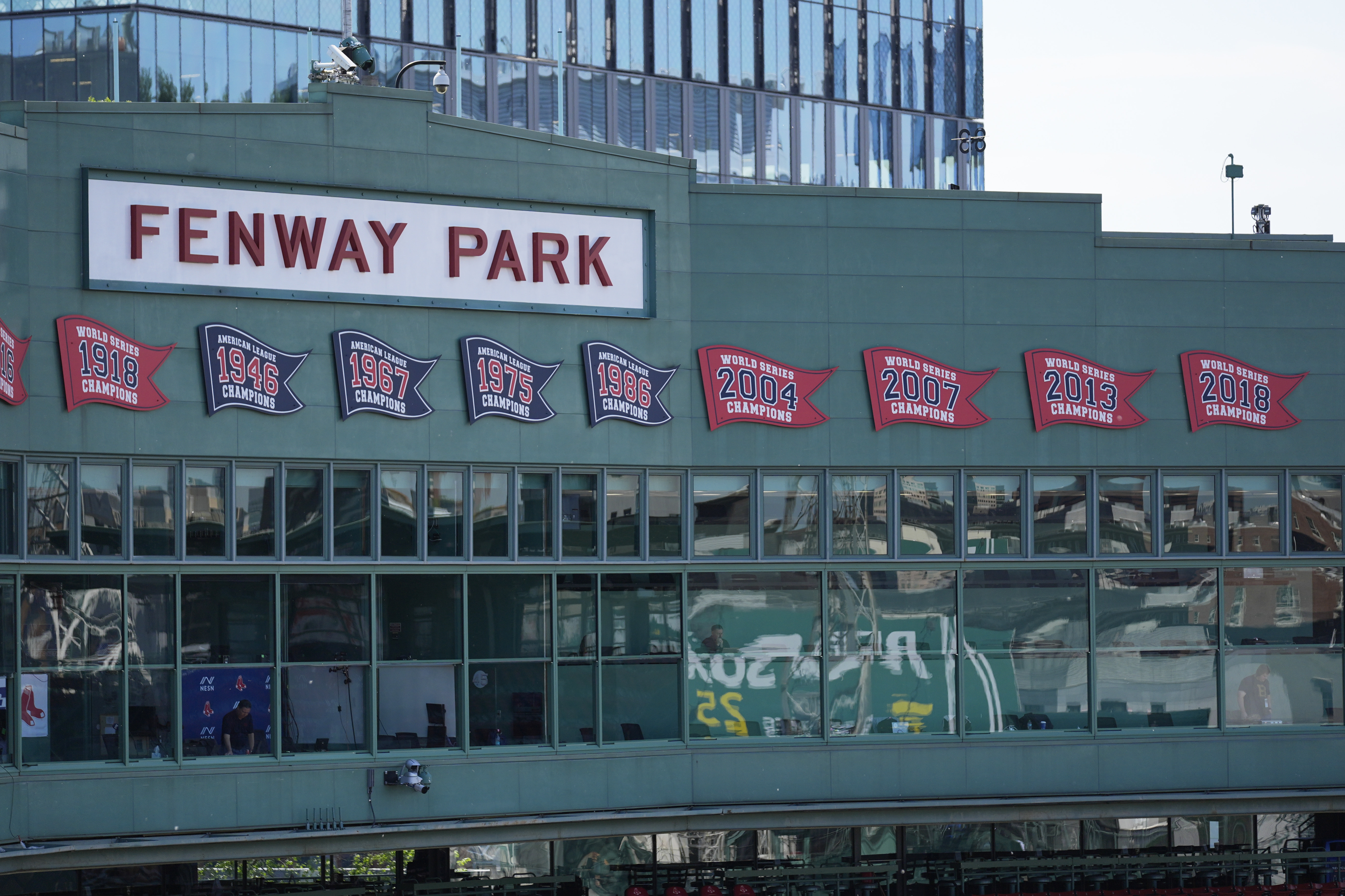 The press box is decorated with championship penants at Fenway Park, Tuesday, June 3, 2025, in Boston.