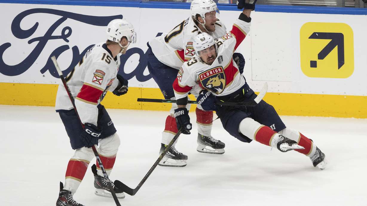 Florida Panthers' Brad Marchand (63) celebrates his game-winning goal against the Edmonton Oilers with Jesper Boqvist (70) and Anton Lundell (15) during the second overtime period in Game 2 of the NHL Stanley Cup final in Edmonton, Friday, June 6, 2025.
