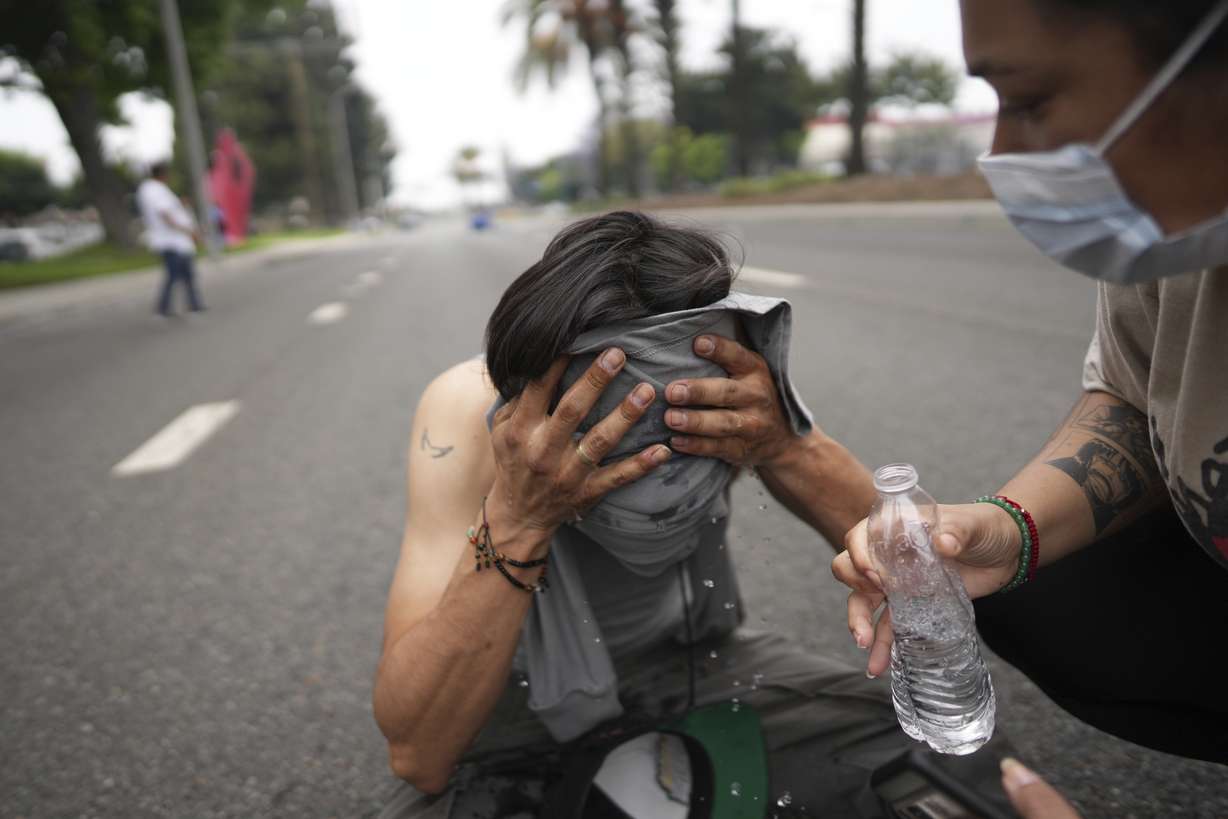 A protester is given aid in Paramount, California, Saturday. The Trump administration deployed 2,000 National Guardsmen in response to continued clashes between federal agents and protestors of immigration raids.