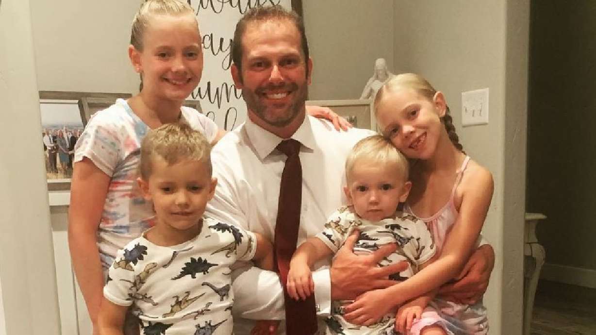 Alex Johnson, 38, with his four children. He was found dead Thursday morning at a church camp in Wasatch County.