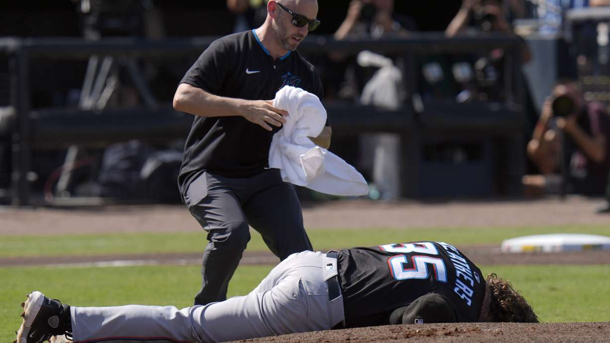 A Miami Marlins trainer rushes out to help pitcher Ryan Weathers after he was hit in the head while teammates were warming up before the first inning of a baseball game Saturday, June 7, 2025, in Tampa, Fla.