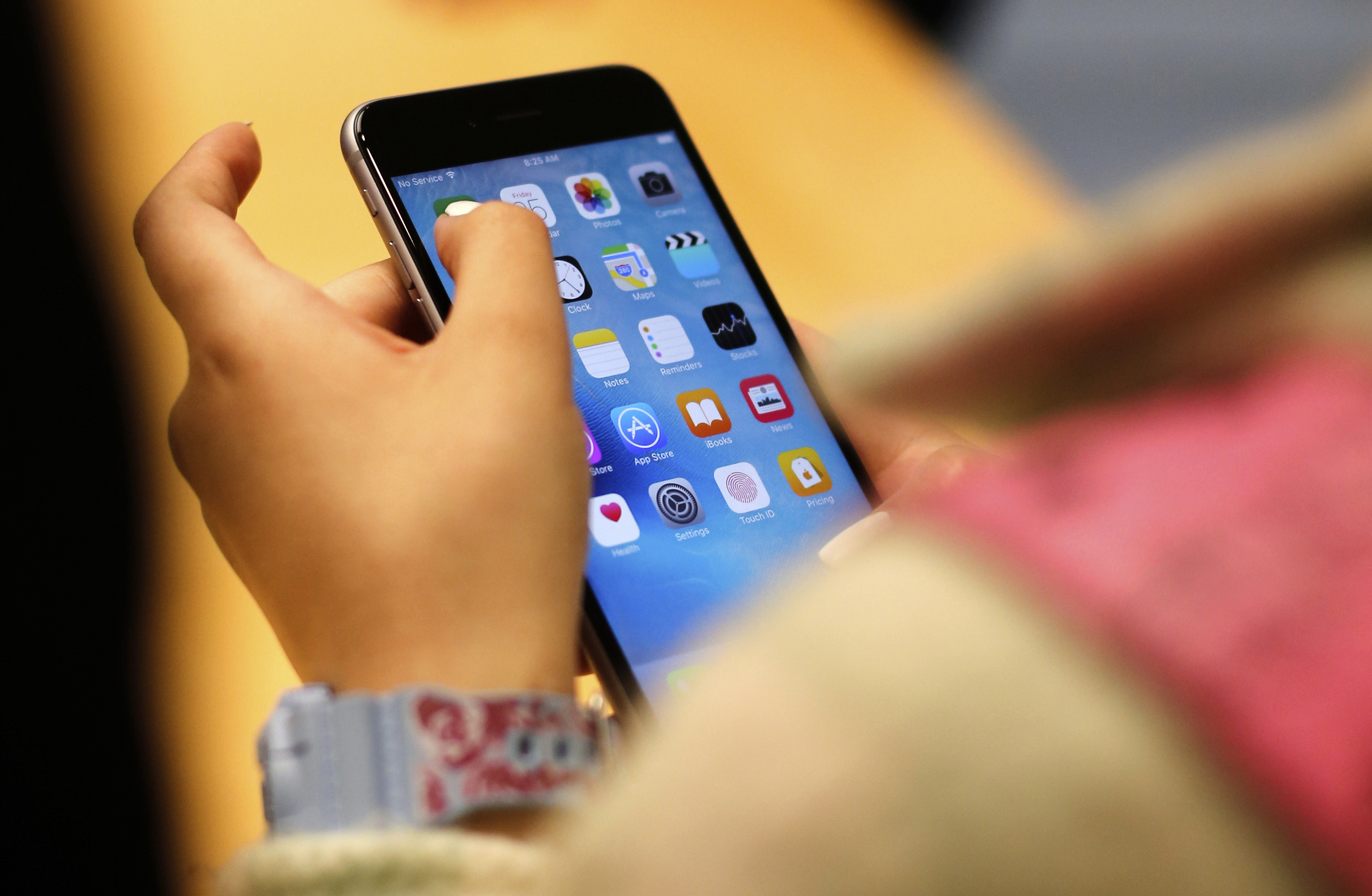 A child holds an iPhone at an Apple store on Sept. 25, 2015, in Chicago. In a digital-first world, information can be found everywhere.