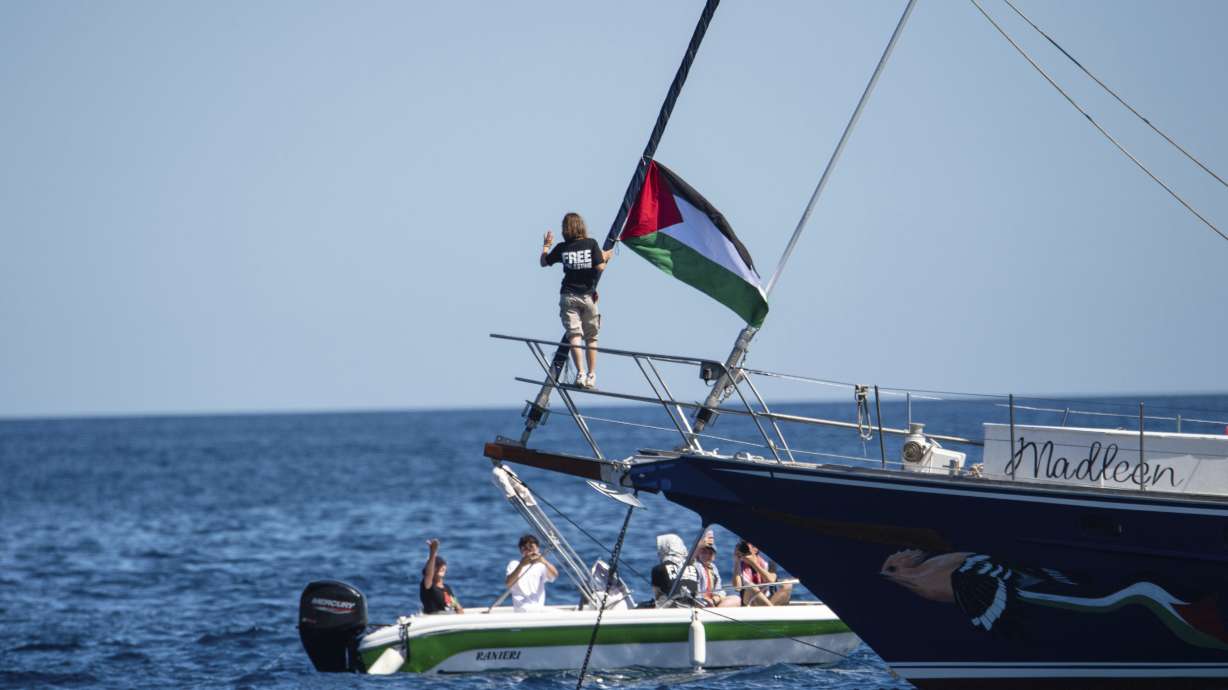 Climate activist Greta Thunberg stands near a Palestinian flag after boarding the Madleen boat and before setting sail for Gaza along with activists of the Freedom Flotilla Coalition, departing from the Sicilian port of Catania, Italy, June 1.