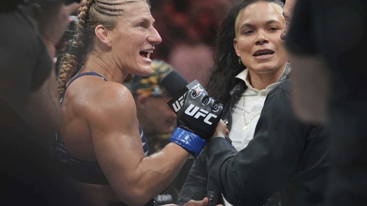 Kayla Harrison, left, talks to Amanda Nunes after her women's bantamweight bout against Julianna Peña at the UFC 316 mixed martial arts event Sunday, June 8, 2025 in Newark, N.J.