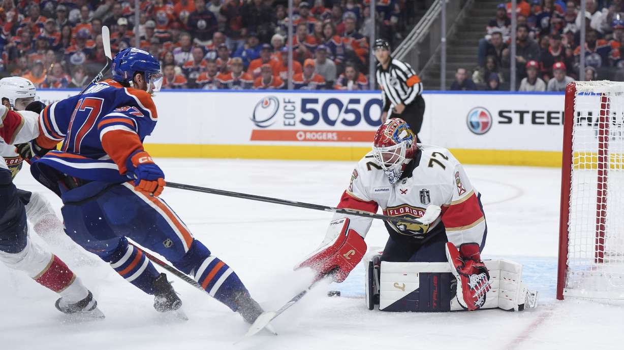 Florida Panthers goalie Sergei Bobrovsky (72) stops Edmonton Oilers' Connor McDavid (97) during the first overtime period in Game 2 of the NHL Stanley Cup Final, in Edmonton, Alberta, Friday, June 6, 2025.
