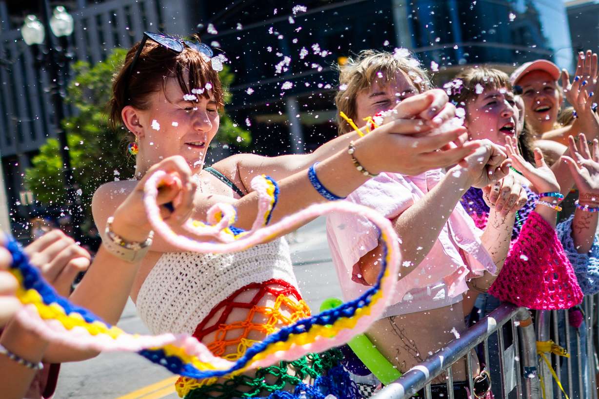 Rori Mcevoy, 17, catches ice that was thrown at them on a hot day during the annual Utah Pride Parade on 100 South in Salt Lake City on Sunday.