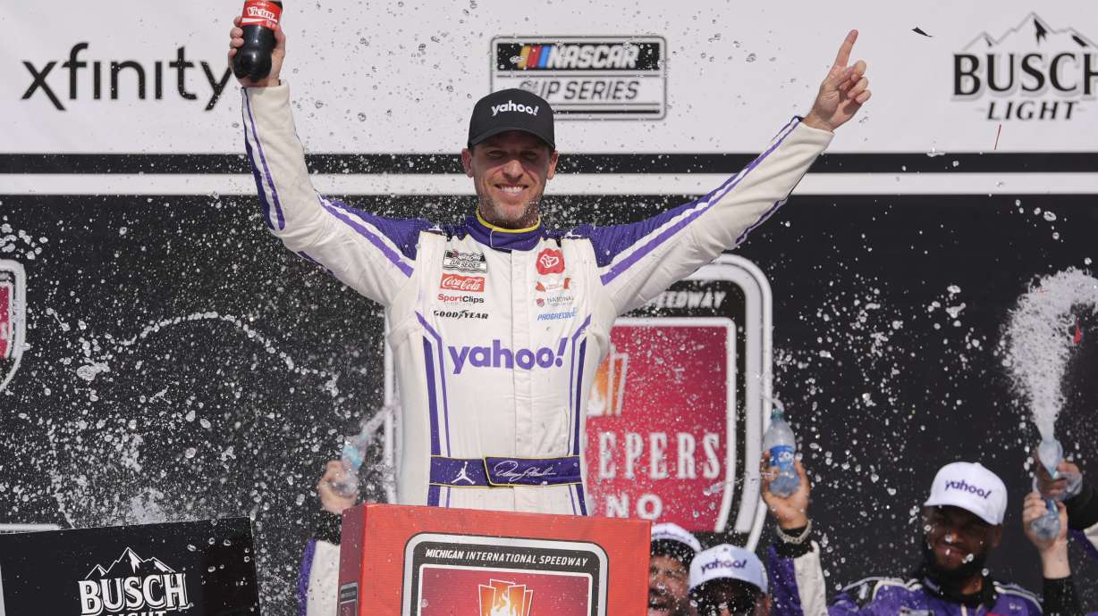 Denny Hamlin celebrates his victory in a NASCAR Cup Series auto race at Michigan International Speedway in Brooklyn, Mich., Sunday, June 8, 2025.