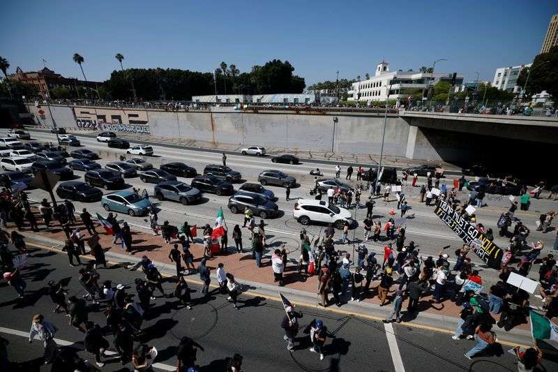 Demonstrators block the highway during a protest against federal immigration sweeps in downtown Los Angeles, Calif., Sunday.