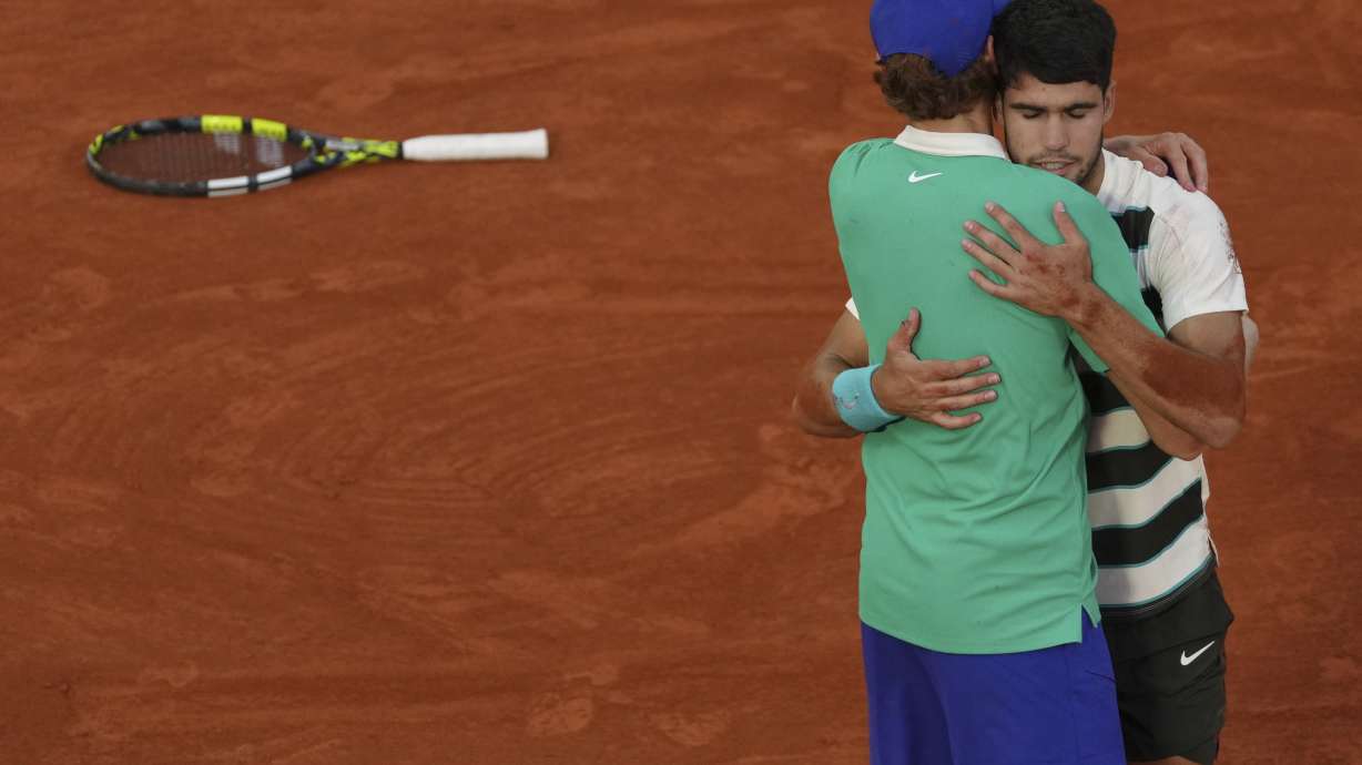 Spain's Carlos Alcaraz hugs Italy's Jannik Sinner after winning the final match of the French Tennis Open at the Roland-Garros in Paris, Sunday, June 8, 2025.