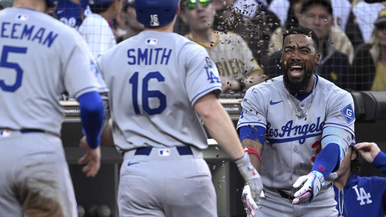 Los Angeles Dodgers' Will Smith (16) has sunflower seeds tossed at him by Teoscar Hernandez, right, after hitting a two-run home run against the San Diego Padres during the third inning of a baseball game Monday, June 9, 2025, in San Diego.