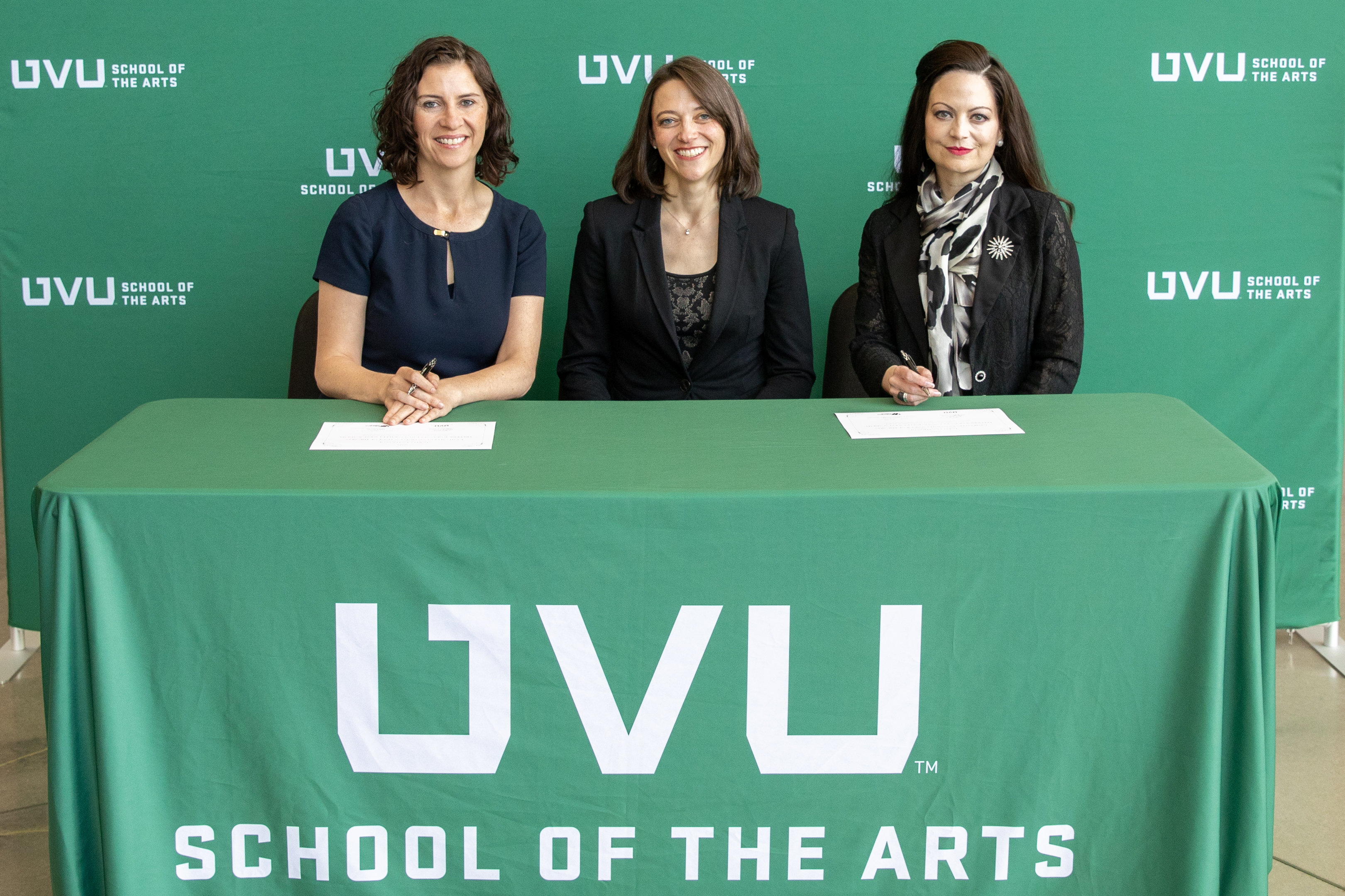 Ballet West's Sarah Taylor and Utah Valley University's Jamie Johnson and Courtney Davis sign papers to implement a partnership to provide Ballet West Academy students the opportunity to earn college credit while training.