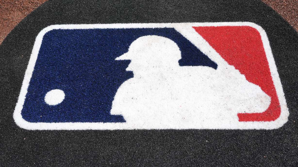 FILE - The Major League Baseball logo is seen on the field before a spring training baseball game between the Pittsburgh Pirates and the Atlanta Braves Tuesday, Feb. 27, 2024, in Bradenton, Fla.