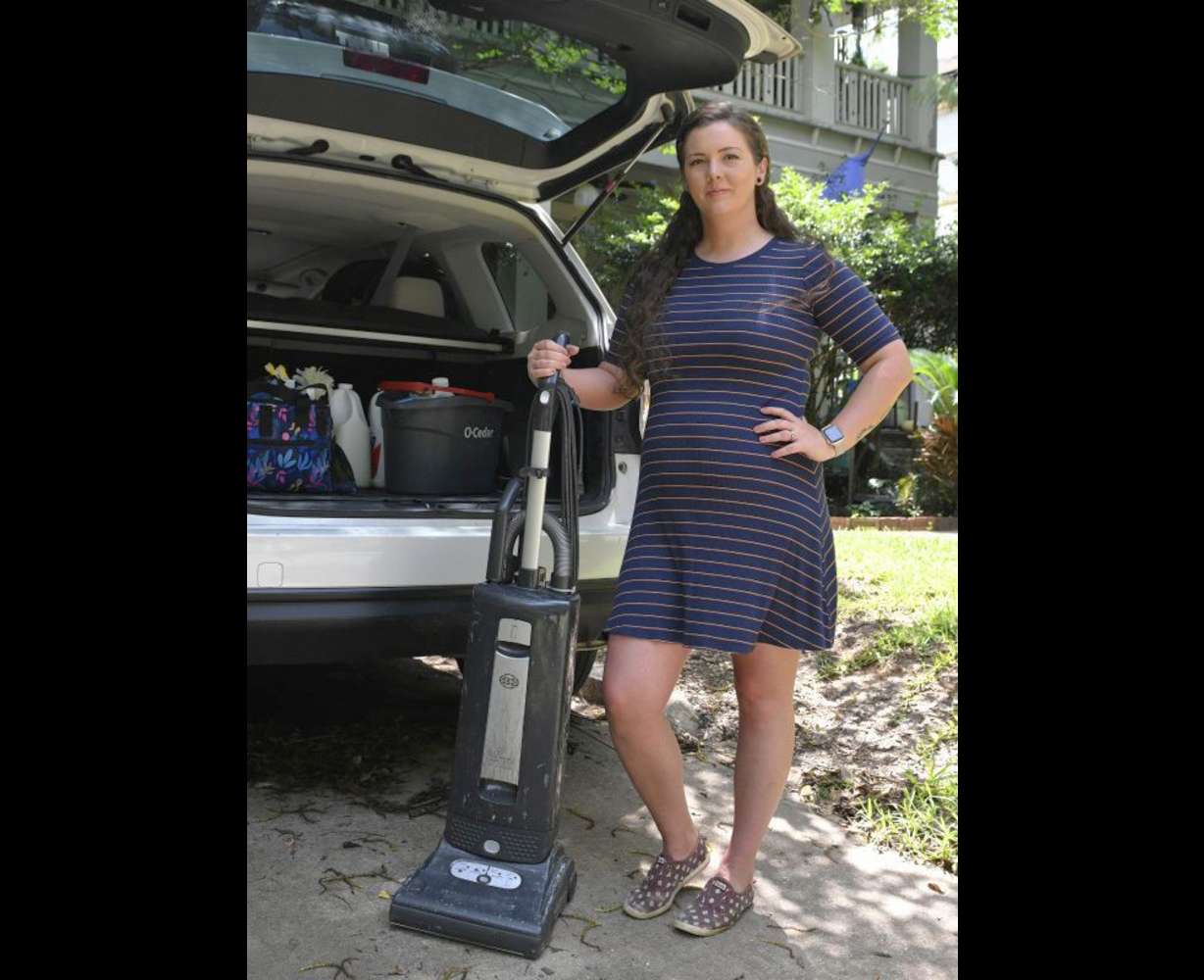 Brittnee Nelson, who runs her own housecleaning business, poses for a portrait in her neighborhood in Shreveport, La., Monday.