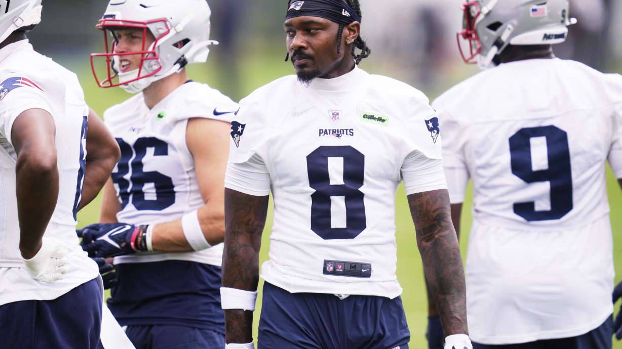 New England Patriots wide receiver Stefon Diggs (8) stands with teammates during an NFL football practice, Monday, June 9, 2025, in Foxborough, Mass.