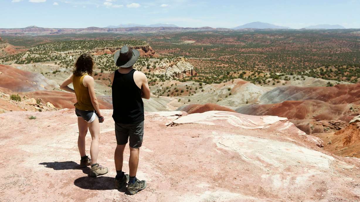 Tourists look at the Grand Staircase-Escalante National Monument on May 14, 2021. An advisory opinion issued Tuesday by the U.S. Department of Justice says protections for land designated as monuments can be abolished by a sitting president.