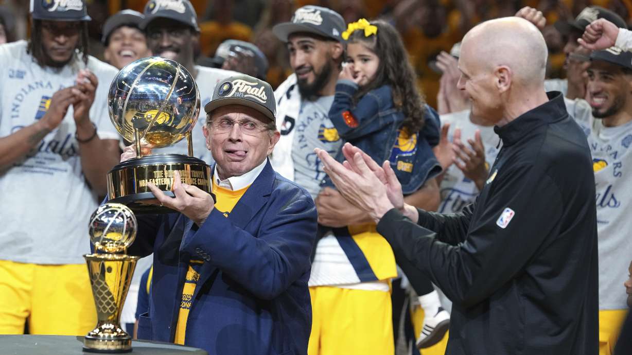 Indiana Pacers owner Herb Simon, left, holds the trophy near head coach Rick Carlisle after the Pacers won Game 6 of the Eastern Conference finals of the NBA basketball playoffs against the New York Knicks in Indianapolis, Saturday, May 31, 2025.