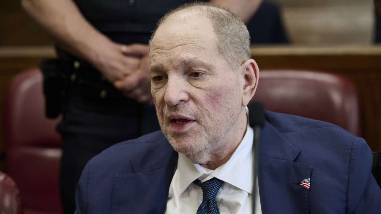 Harvey Weinstein jokes with press photographers in Manhattan criminal court Wednesday in New York. Weinstein was convicted of a top charge in his sex crimes retrial in a split verdict.
