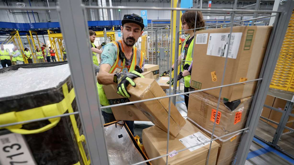 Zac Palmer works as an associate at the Marriott-Slaterville Amazon Delivery Station, the last stop before packages are delivered to customers, in Marriott-Slaterville on Tuesday.