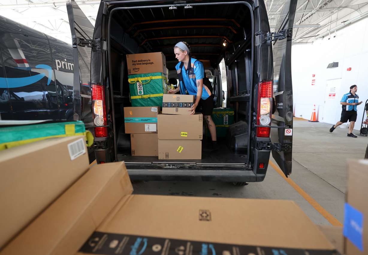 Ariana Alexander loads a van up with packages to deliver at the Marriott-Slaterville Amazon Delivery Station, the last stop before packages are delivered to customers, in Marriott-Slaterville on Tuesday.