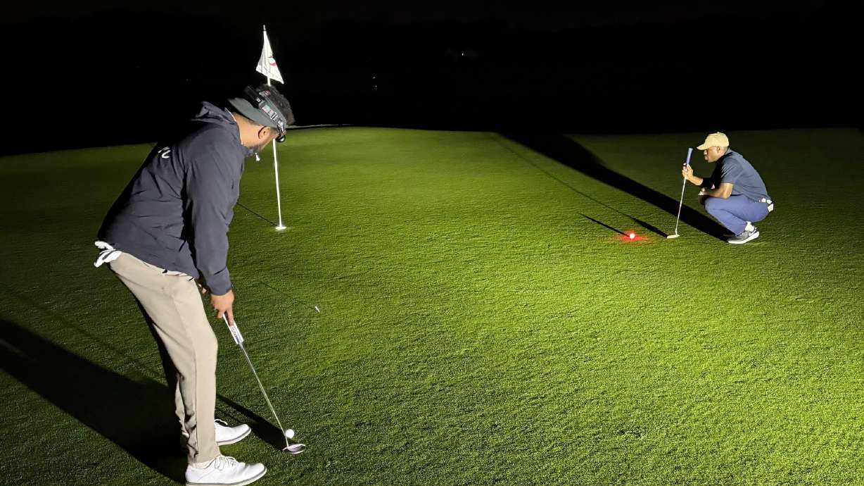 Kelechi Ezihie, right, plays golf at the Huntington Crescent Club in Huntington, N.Y., where he played for 35 straight hours, between Sunday, June 8, 2025 to Tuesday, June 10, 2025, and is seeking validation of the Guinness World Record.