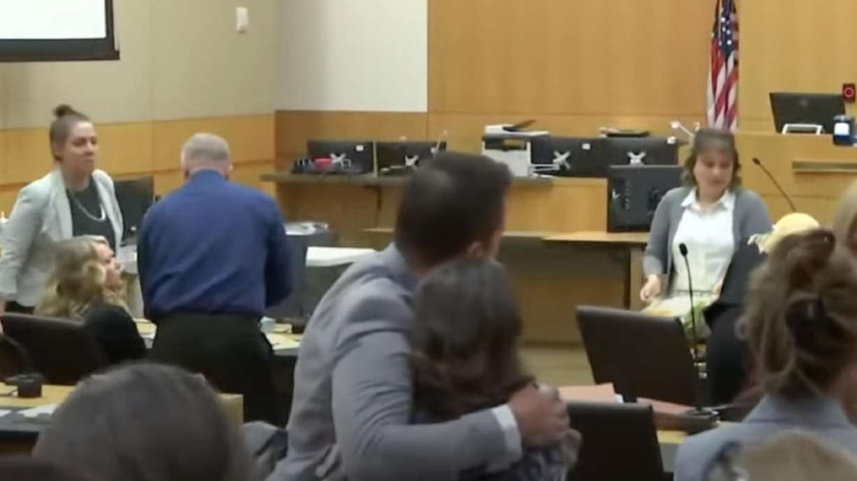 Brandon Boudreaux hugs Kay Woodcock after the end of Lori Daybell's third jury trial on Wednesday. She is on trial for conspiring to murder Boudreaux, who was shot at outside his home.