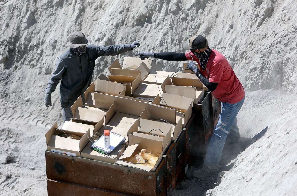 Department of the Army civilian explosives operators wire in explosives for open detonations during demilitarization operations at the Tooele Army Depot in Tooele County on Wednesday.