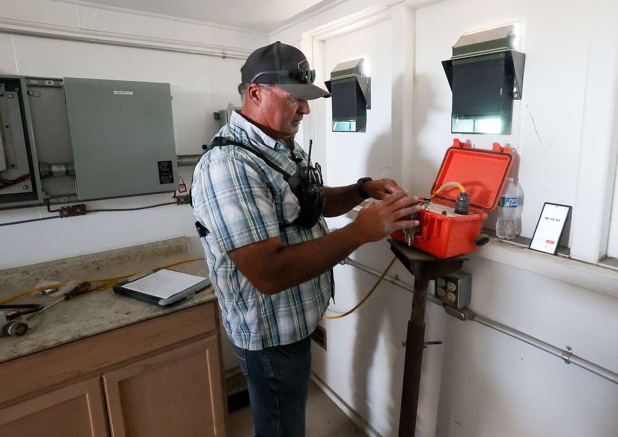 Shawn Anderson operates a control box that triggers open detonations during demilitarization operations from a protected “shooter shack” at the Tooele Army Depot in Tooele County on Wednesday.