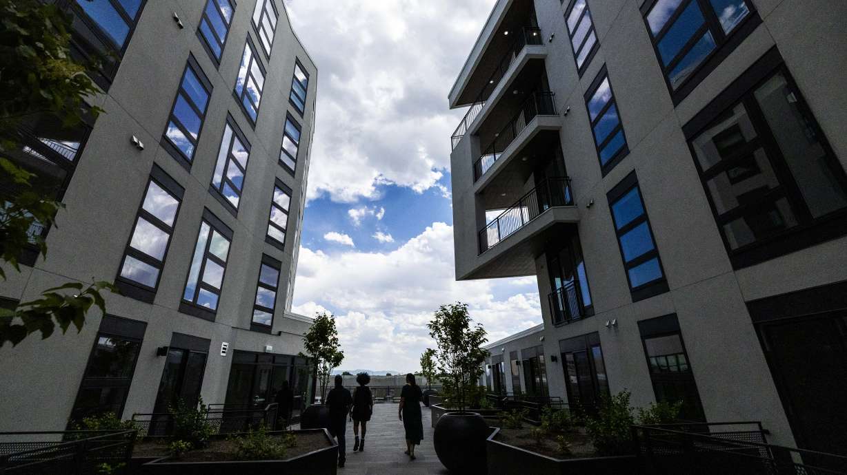 People tour the One Burton at the grand opening of the downtown South Salt Lake development on Wednesday. The eight-story building includes 180 units, ranging from studios to two-bedroom rentals.