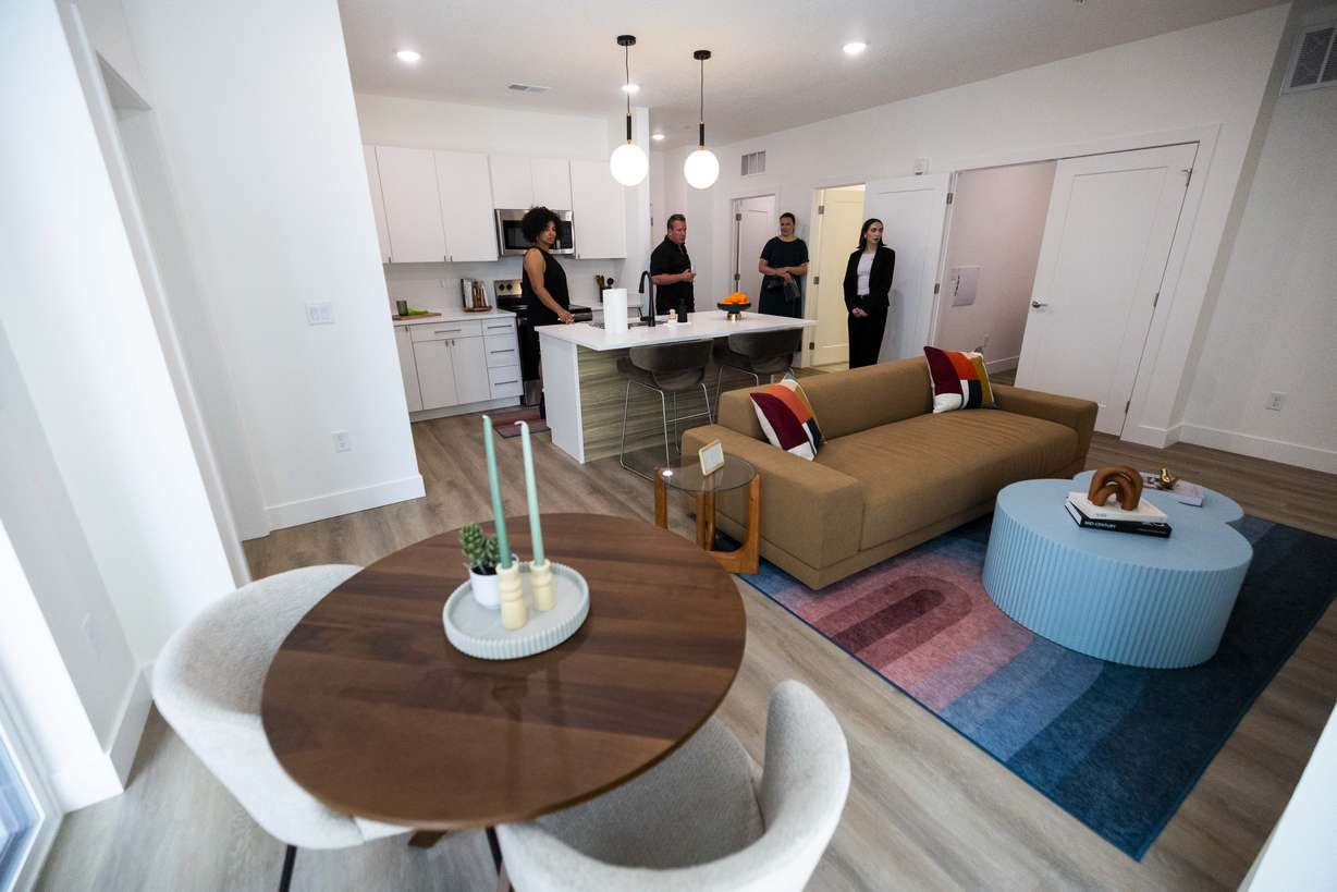 People tour an apartment during the grand opening of the One Burton development in downtown South Salt Lake on Wednesday. The eight-story building includes 180 rental residences across 24 floor plans, ranging from studios to two-bedroom rental units.