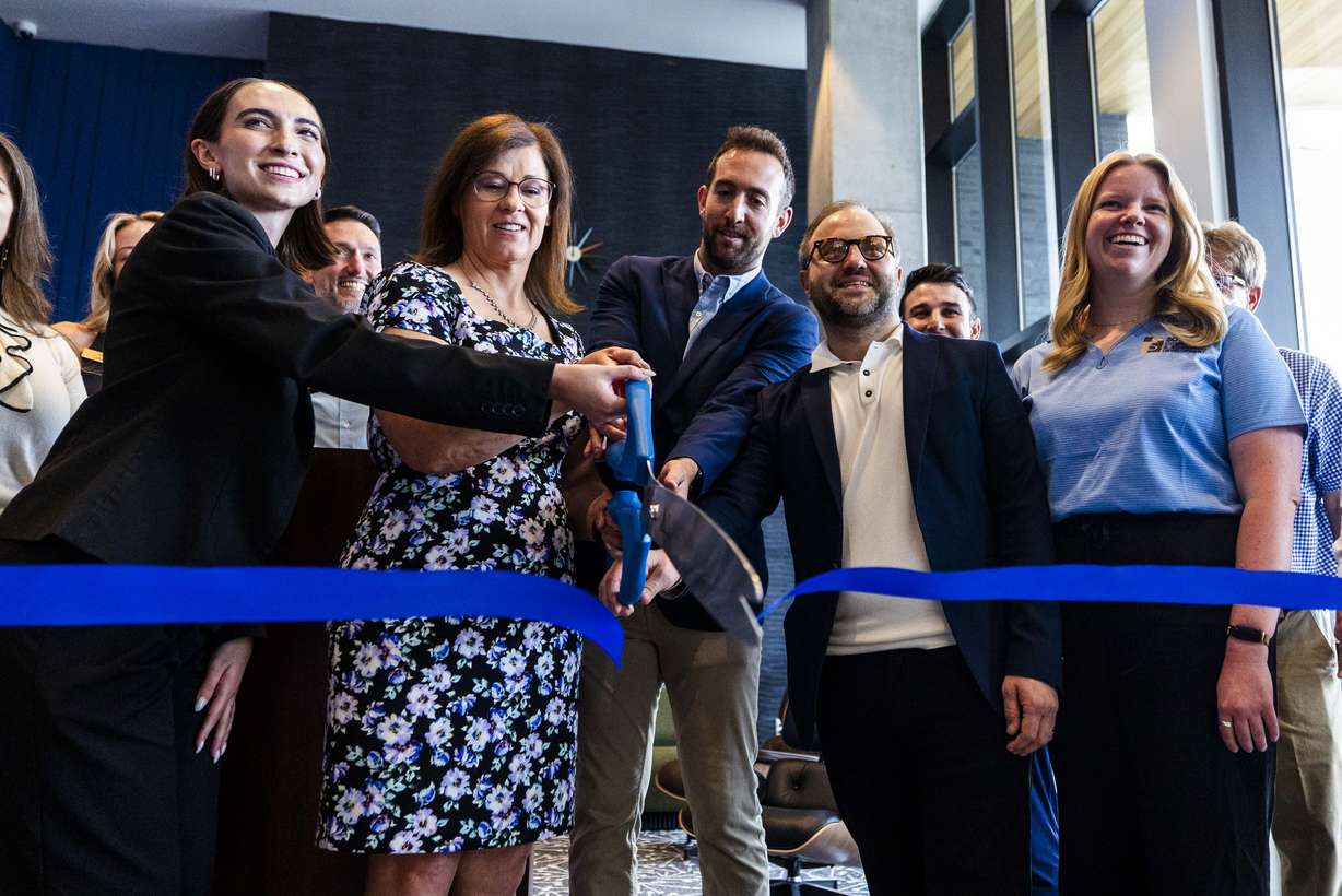 From left to right, One Burton community manager Makayla Wade, South Salt Lake Mayor Cherie Wood, and Daniel Rudofsky and Jason Algaze, both partners at Abstract Development, all smile as they cut the ribbon during the grand opening of the One Burton development in downtown South Salt Lake on Wednesday. The eight-story building includes 180 rental residences across 24 floor plans, ranging from studios to two-bedroom rental units.