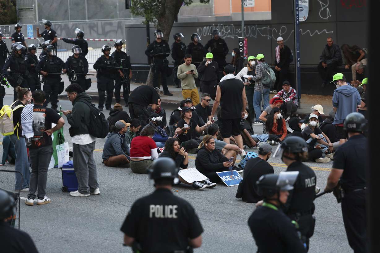 Los Angeles police officers surround protesters under arrest on Wednesday. Officials said Marines would arrive in two days to support law enforcement, with power to detain civilians.