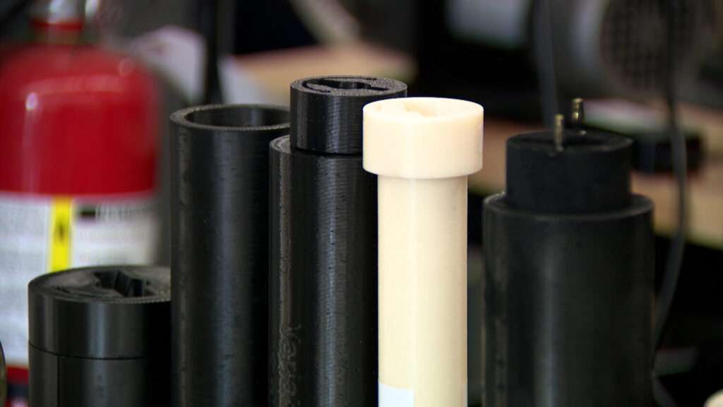 Some examples of 3D-printed fuel sources are shown in Logan on Wednesday. The fuel is used for a hybrid rocket motor that could help astronauts land on and take off from the moon.