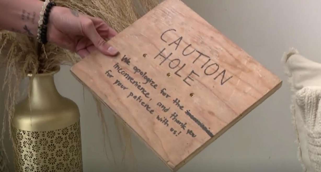 Studio owner Winter Hoins said her landlord left her this note due to a hole in the floor during renovations at her downtown photography studio, saying, "We apologize for the inconvenience, and thank you for your patience with us!"