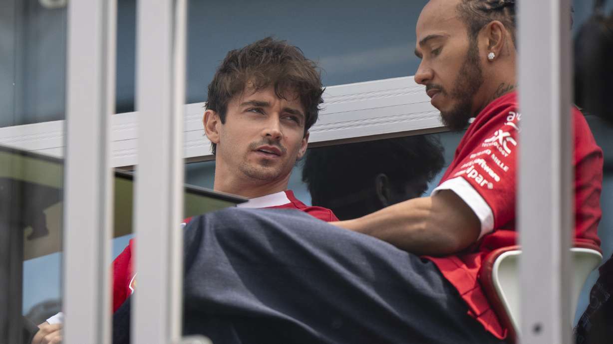 Ferrari driver Charles Leclerc, left, of Monaco, speaks with Lewis Hamilton, of Britain, at the F1 Canadian Grand Prix auto race, Thursday, June 12, 2025, in Montreal.