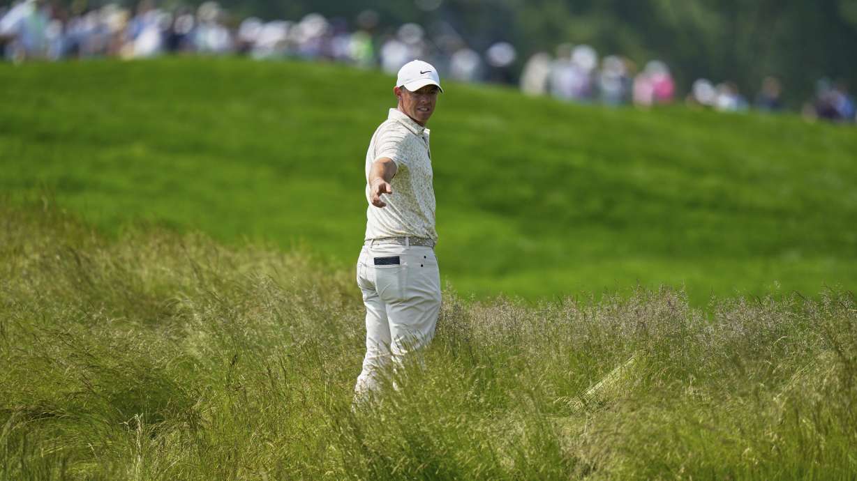 Rory McIlroy, of Northern Ireland, prepares to hit from the tall grass on the fourth hole during the first round of the U.S. Open golf tournament at Oakmont Country Club Thursday, June 12, 2025, in Oakmont, Pa.