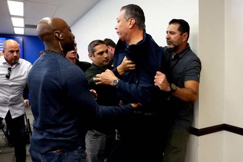 U.S. Senator Alex Padilla (D-CA), who interrupted the press conference held by Secretary of Homeland Security Kristi Noem, is removed from the venue, in Los Angeles, Thursday. Padilla and Noem later agreed to continue talking about concerns over immigration raids.