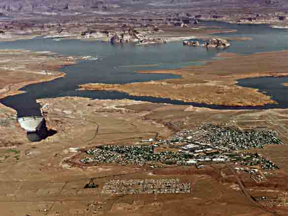 An aerial view of Glen Canyon Dam, Lake Powell, and the town of Page, Arizona.